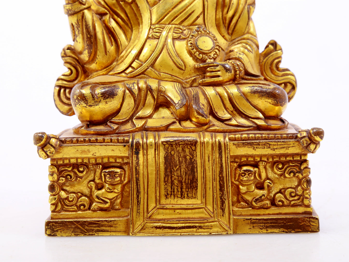 A serene gilt bronze statue of the Guru