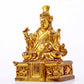 A serene gilt bronze statue of the Guru