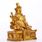 A serene gilt bronze statue of the Guru