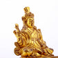 A serene gilt bronze statue of the Guru