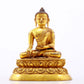 A serene gilt bronze statue of Gautama Buddha