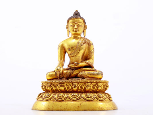 A serene gilt bronze statue of Gautama Buddha