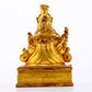 A serene gilt bronze statue of the Guru