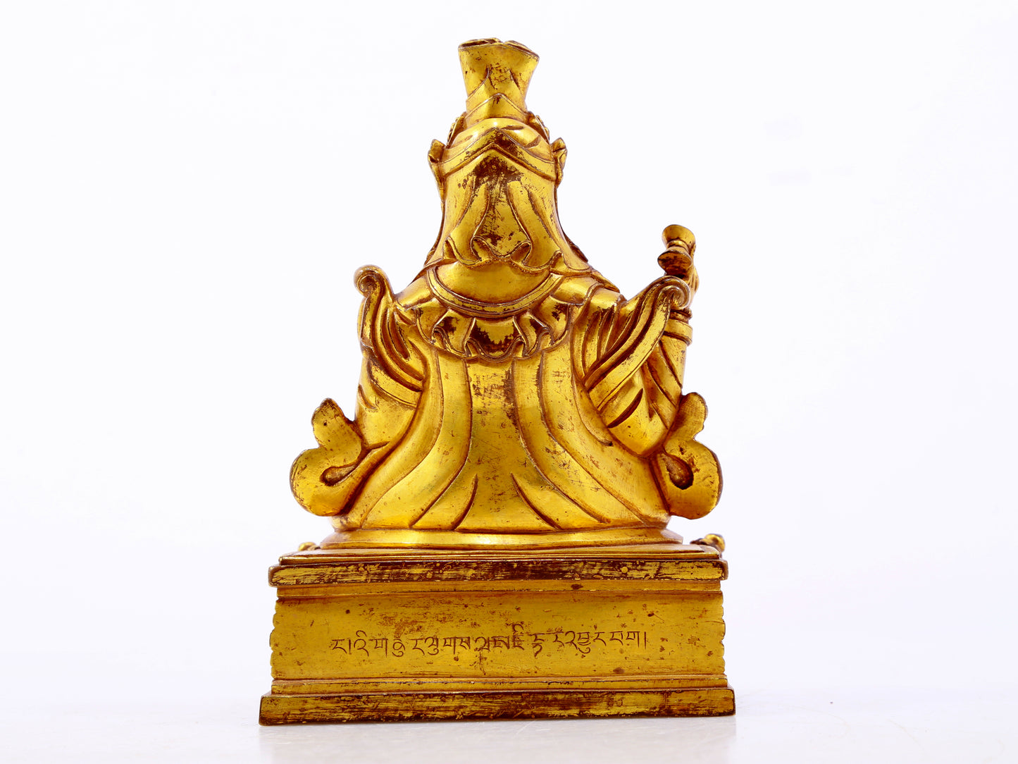 A serene gilt bronze statue of the Guru