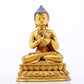 A serene gilt bronze statue of Gautama Buddha