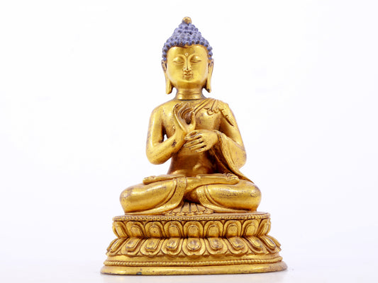 A serene gilt bronze statue of Gautama Buddha