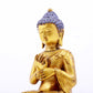 A serene gilt bronze statue of Gautama Buddha