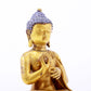 A serene gilt bronze statue of Gautama Buddha