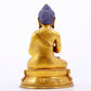 A serene gilt bronze statue of Gautama Buddha