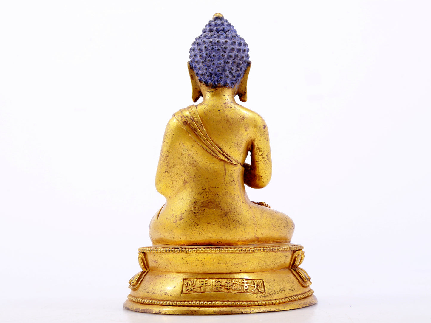 A serene gilt bronze statue of Gautama Buddha