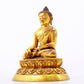 A serene gilt bronze statue of Gautama Buddha