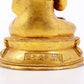 A serene gilt bronze statue of Gautama Buddha