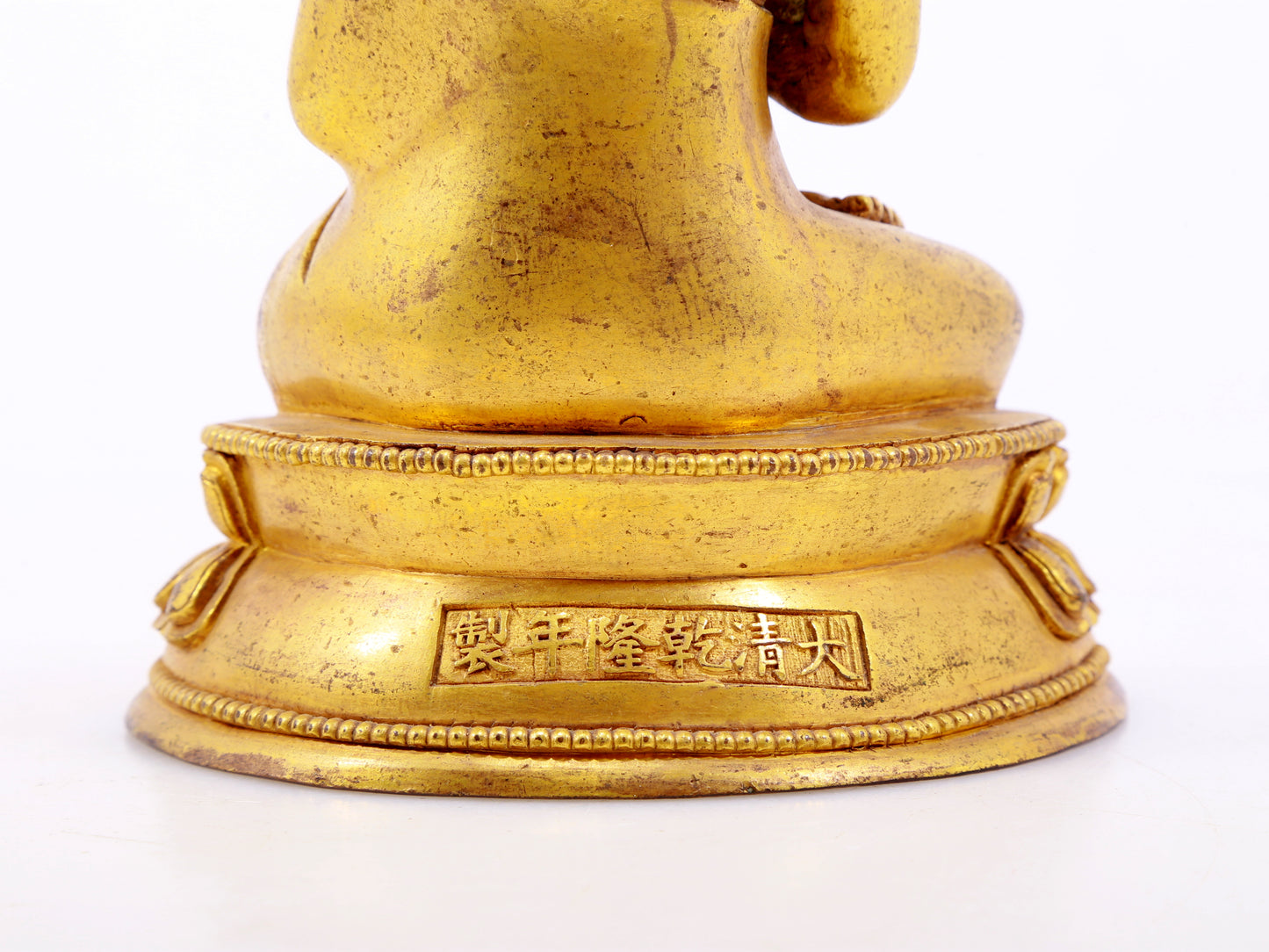 A serene gilt bronze statue of Gautama Buddha