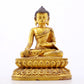 A serene gilt bronze statue of Gautama Buddha