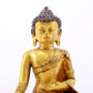 A serene gilt bronze statue of Gautama Buddha