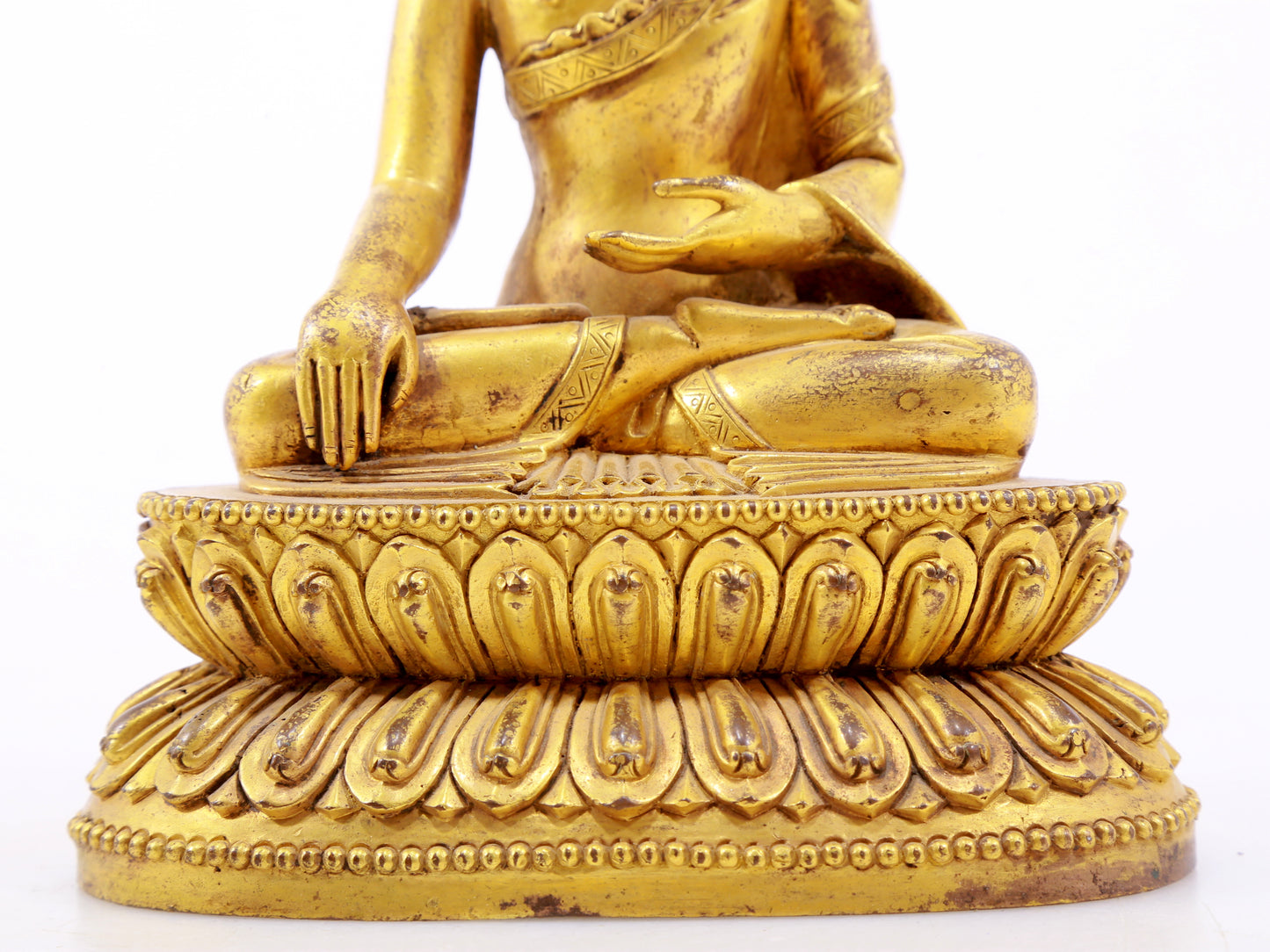 A serene gilt bronze statue of Gautama Buddha