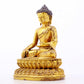 A serene gilt bronze statue of Gautama Buddha