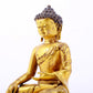 A serene gilt bronze statue of Gautama Buddha