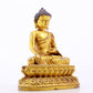 A serene gilt bronze statue of Gautama Buddha