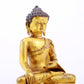 A serene gilt bronze statue of Gautama Buddha