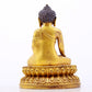 A serene gilt bronze statue of Gautama Buddha