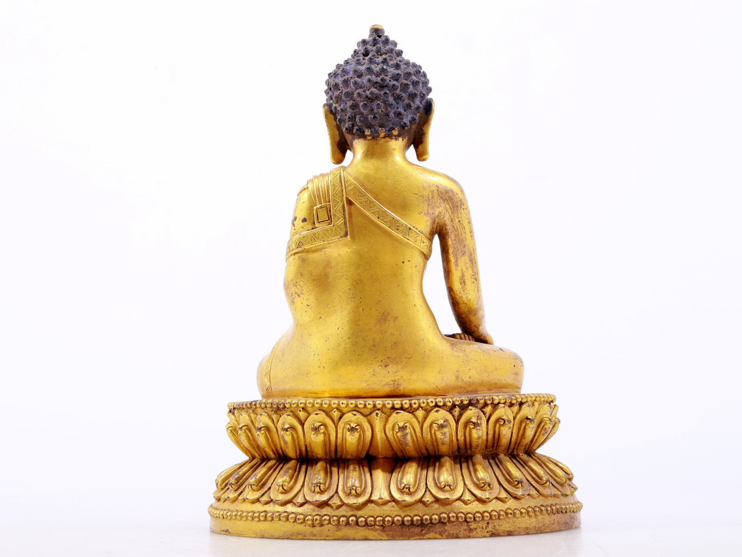 A serene gilt bronze statue of Gautama Buddha