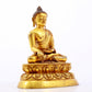 A serene gilt bronze statue of Gautama Buddha