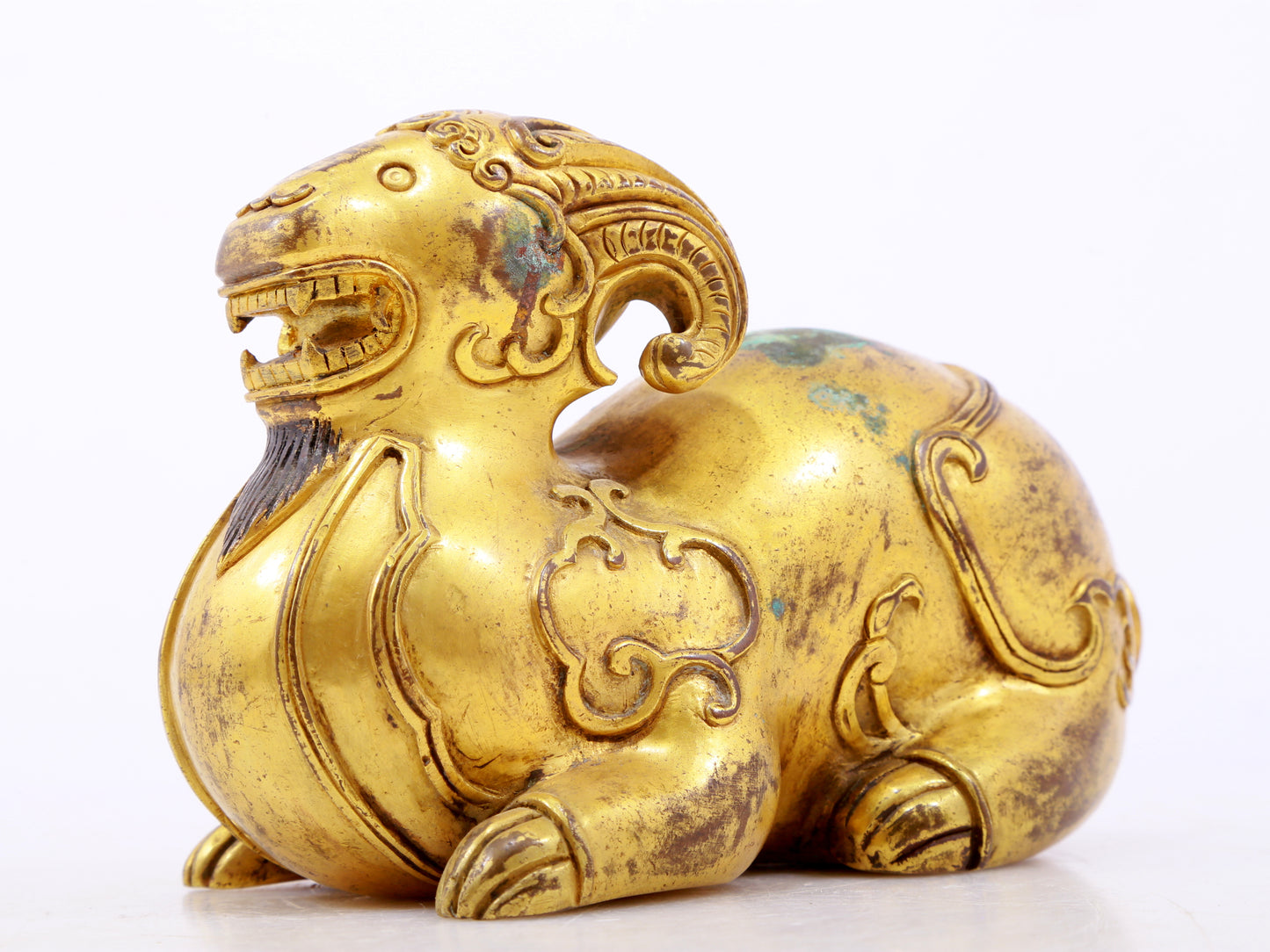 A serene gilt bronze auspicious animal ornaments