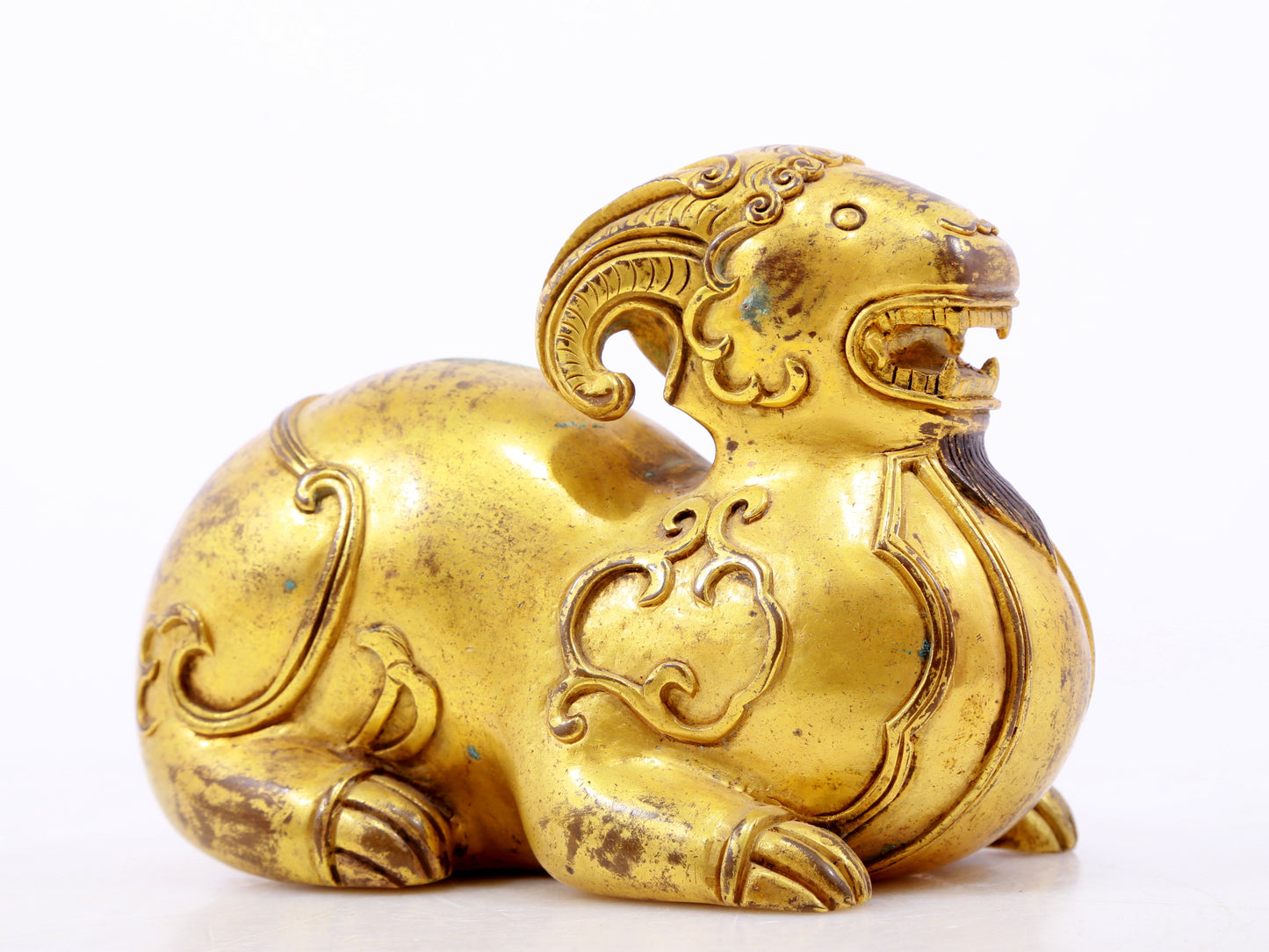 A serene gilt bronze auspicious animal ornaments