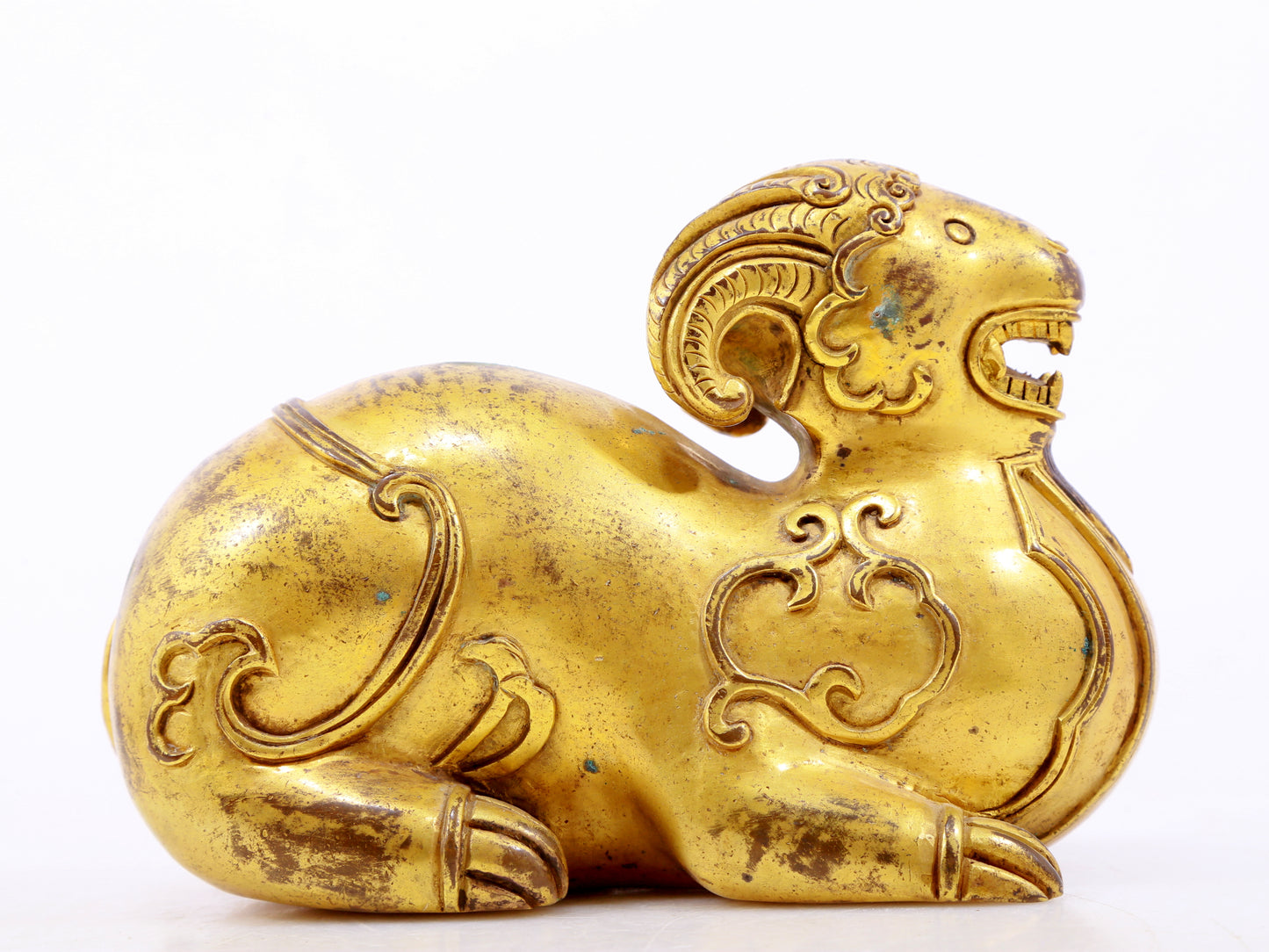 A serene gilt bronze auspicious animal ornaments