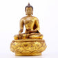 A serene gilt bronze statue of Gautama Buddha