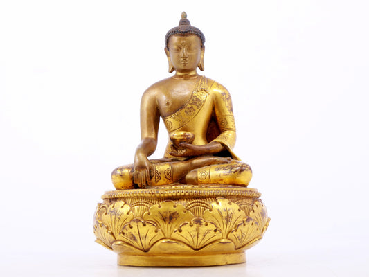 A serene gilt bronze statue of Gautama Buddha