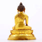 A serene gilt bronze statue of Gautama Buddha