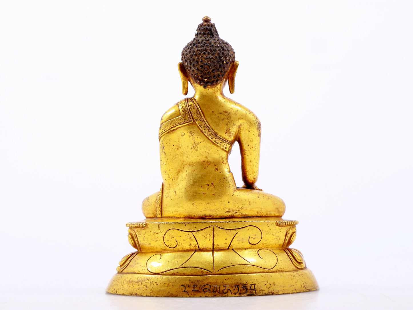 A serene gilt bronze statue of Gautama Buddha