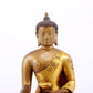 A serene gilt bronze statue of Gautama Buddha