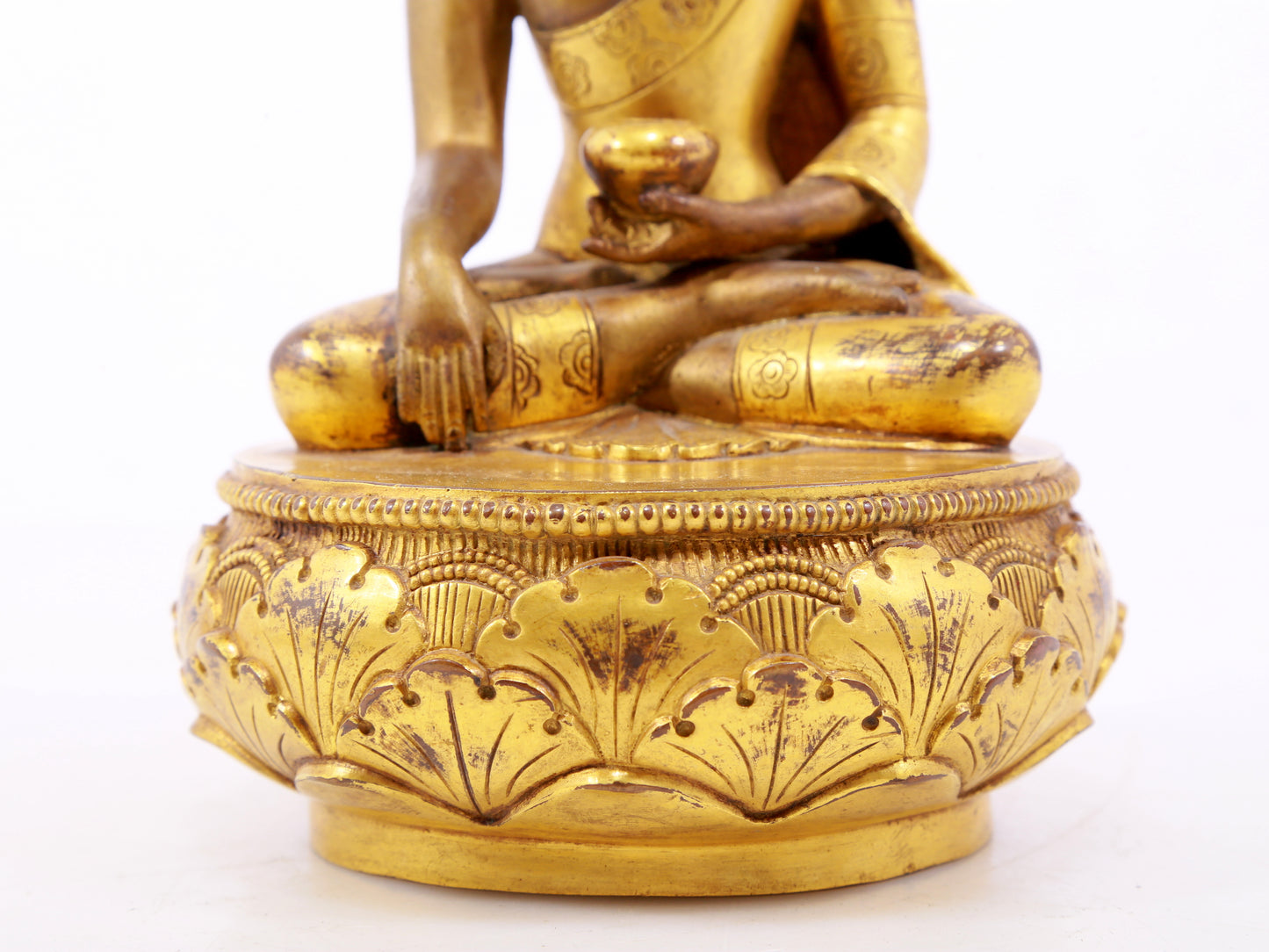 A serene gilt bronze statue of Gautama Buddha