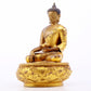 A serene gilt bronze statue of Gautama Buddha