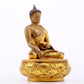 A serene gilt bronze statue of Gautama Buddha