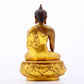 A serene gilt bronze statue of Gautama Buddha