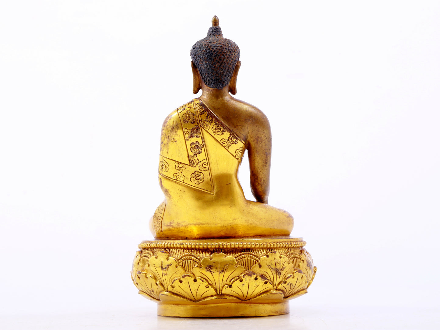 A serene gilt bronze statue of Gautama Buddha