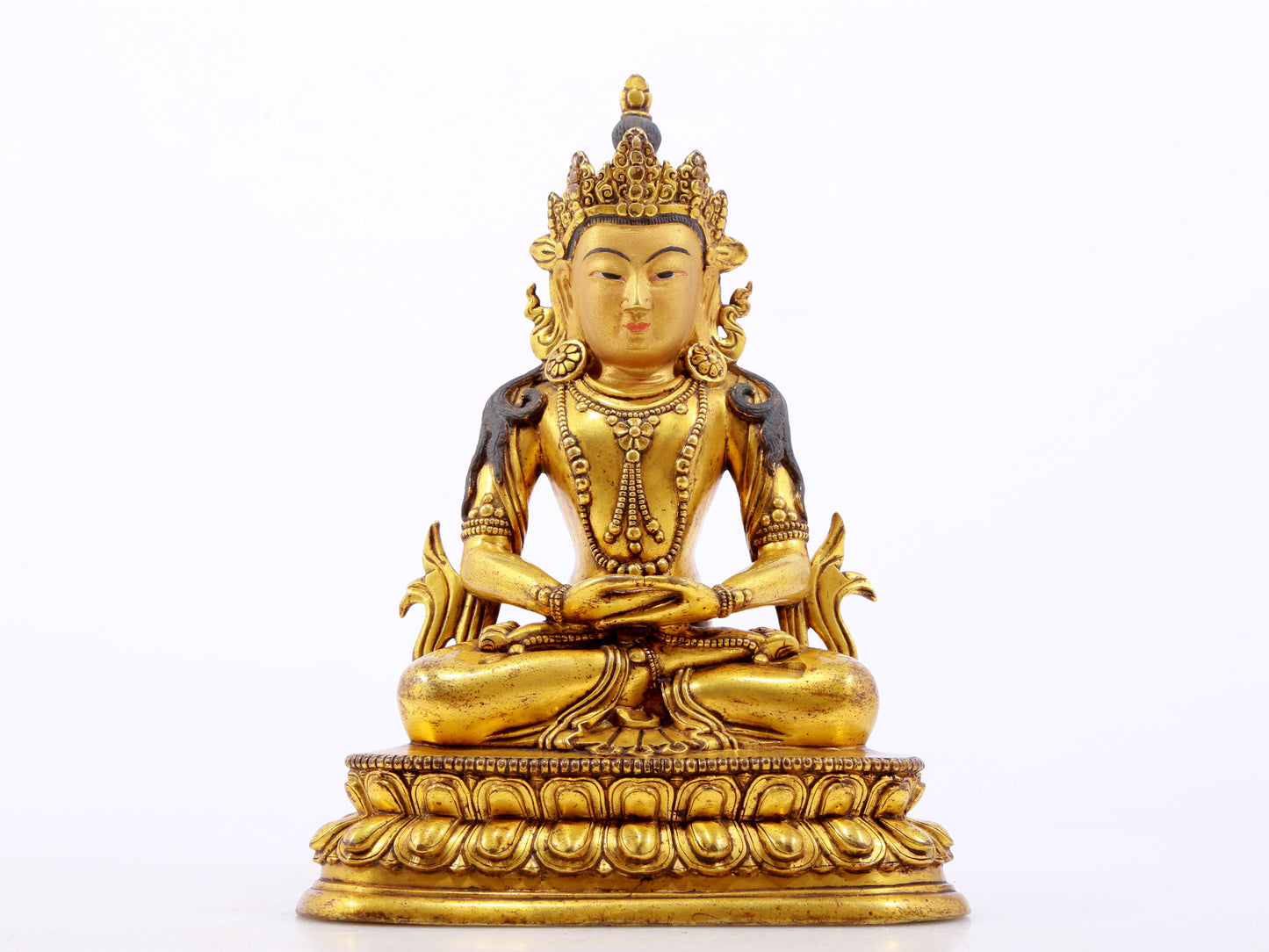 A serene gilt bronze statue of Amitayus Buddha