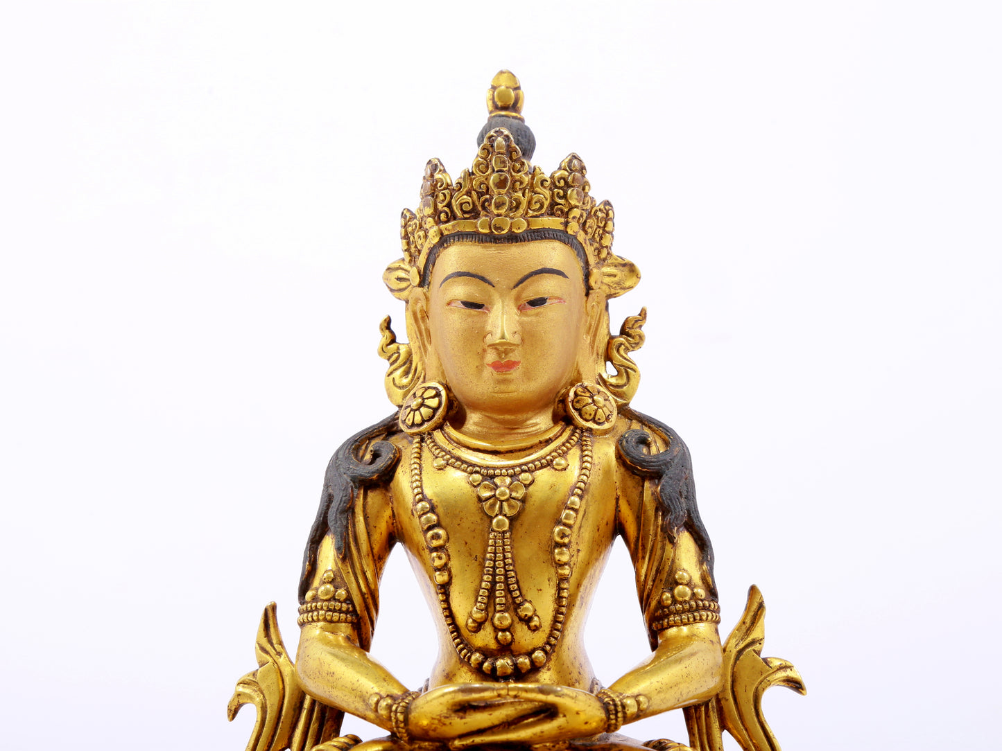 A serene gilt bronze statue of Amitayus Buddha