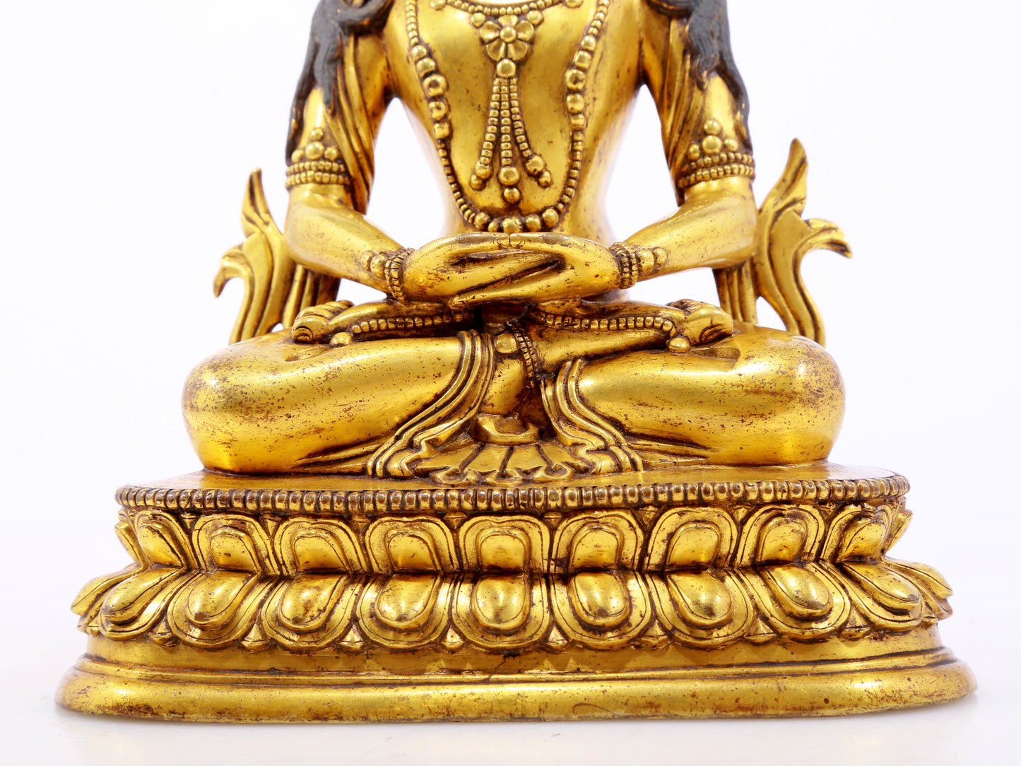 A serene gilt bronze statue of Amitayus Buddha