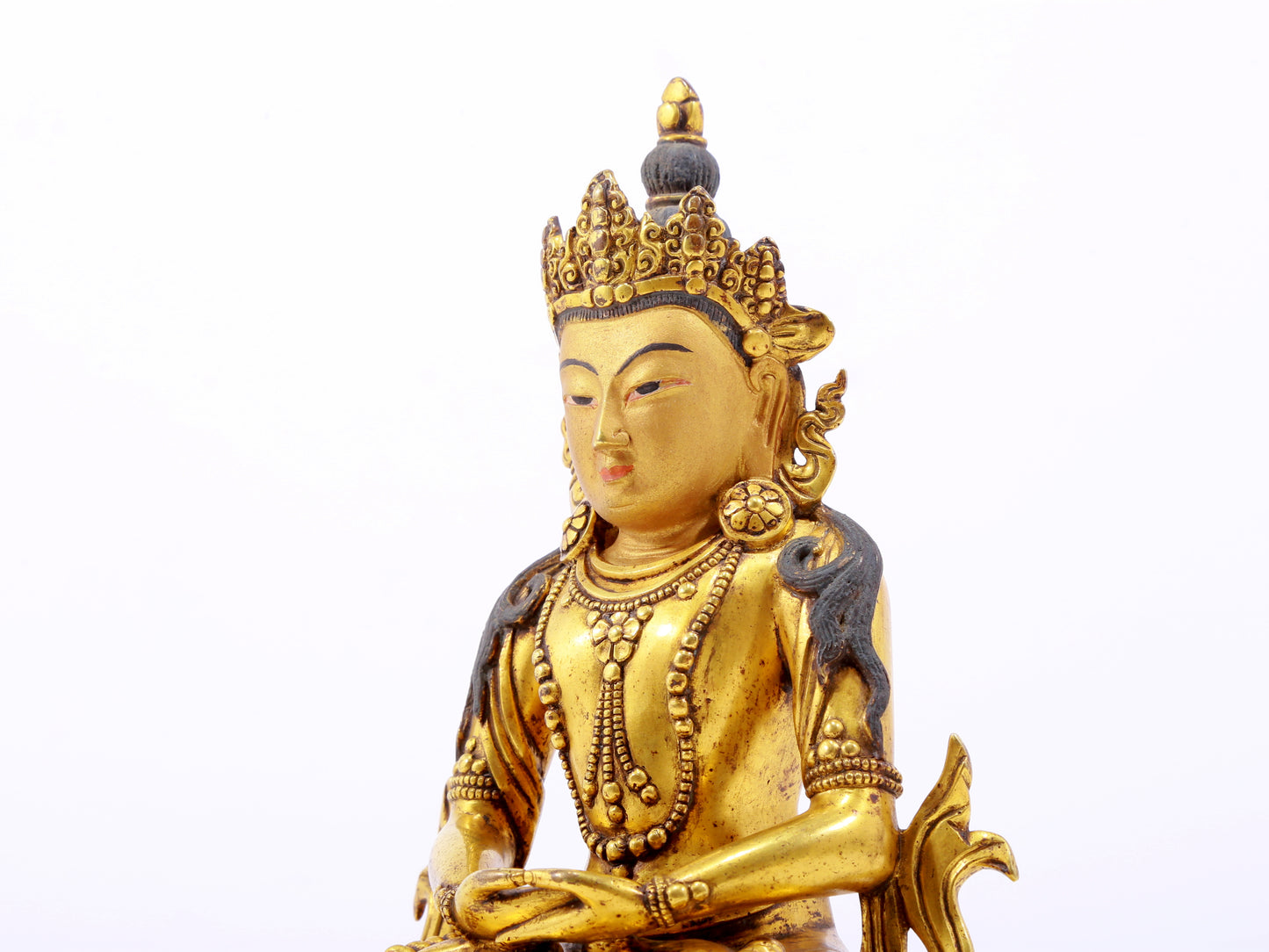 A serene gilt bronze statue of Amitayus Buddha