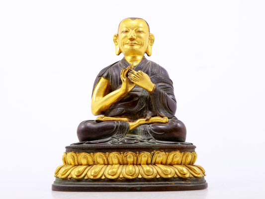 A serene gilt bronze statue of the master