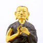 A serene gilt bronze statue of the master