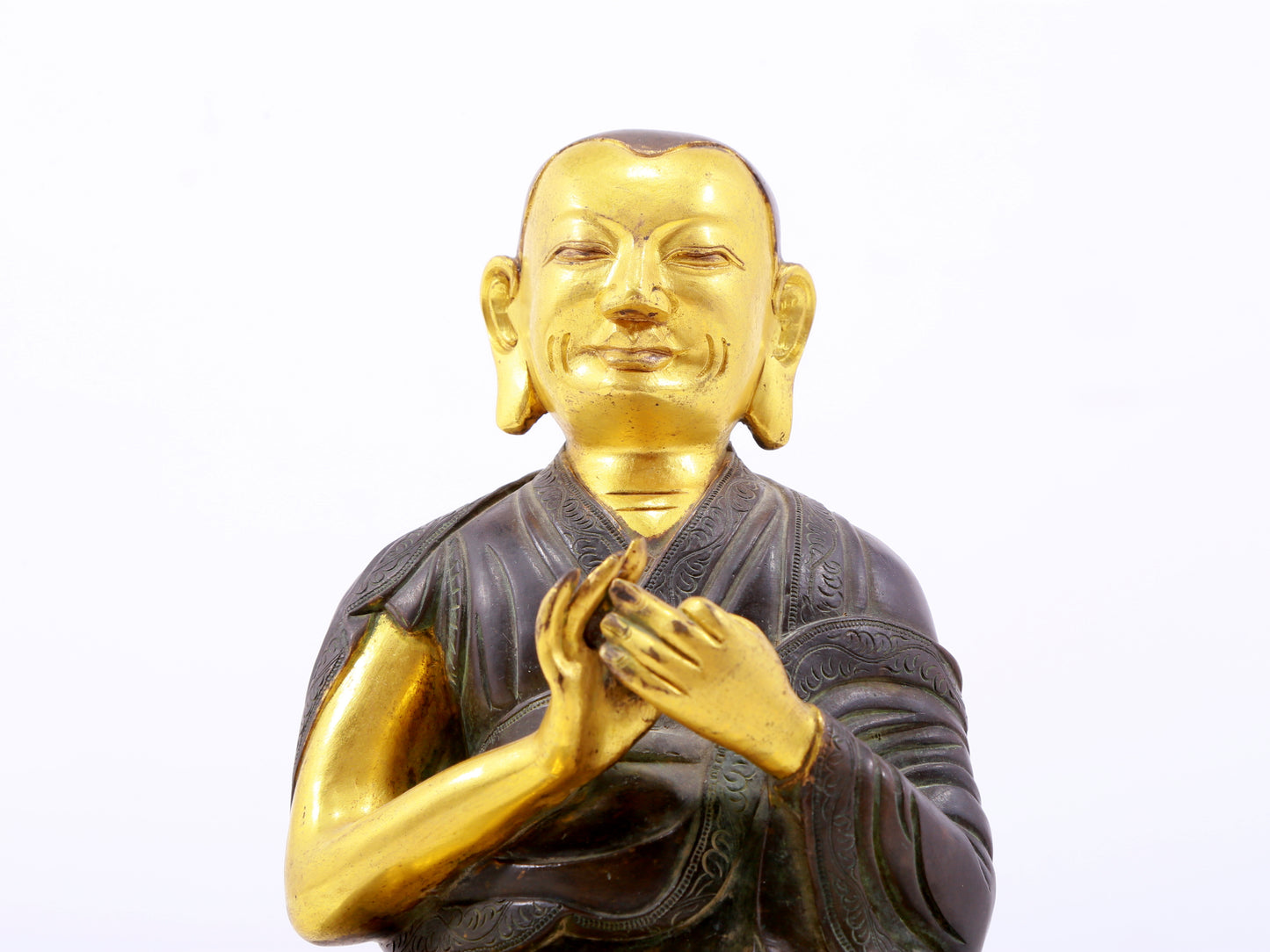 A serene gilt bronze statue of the master