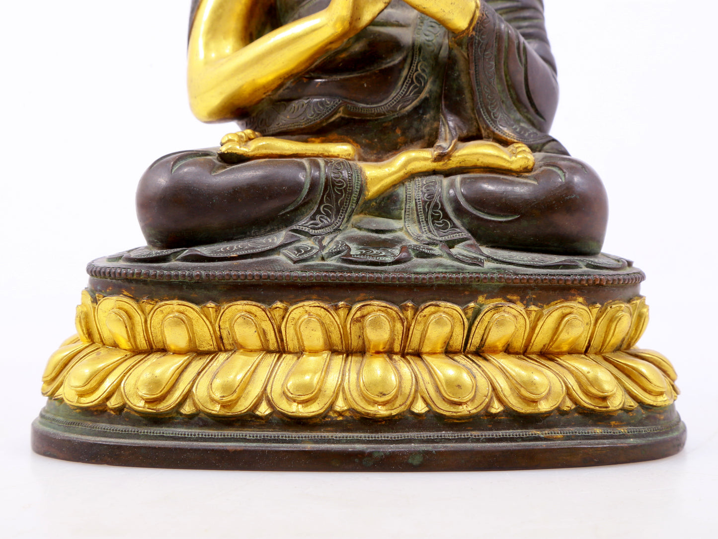 A serene gilt bronze statue of the master