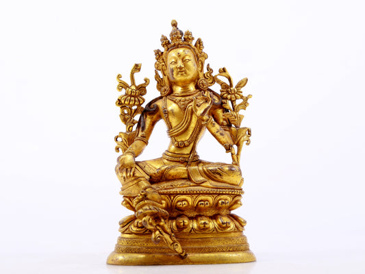 A serene gilt bronze green Tara statue