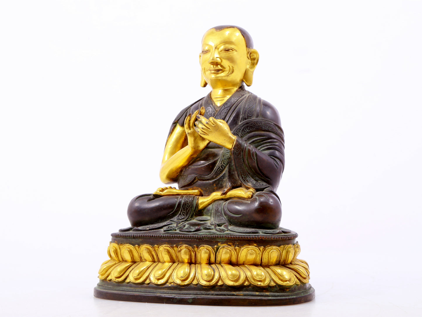 A serene gilt bronze statue of the master